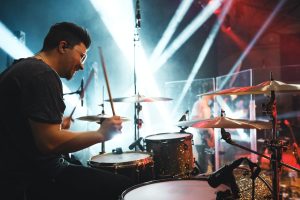 drummer behind plexiglass sound barrier